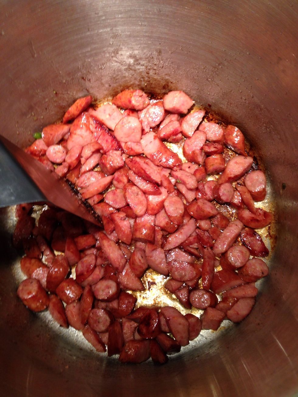 Saut\u00e9 the sausage until slightly browned, reserve the grease and set aside.