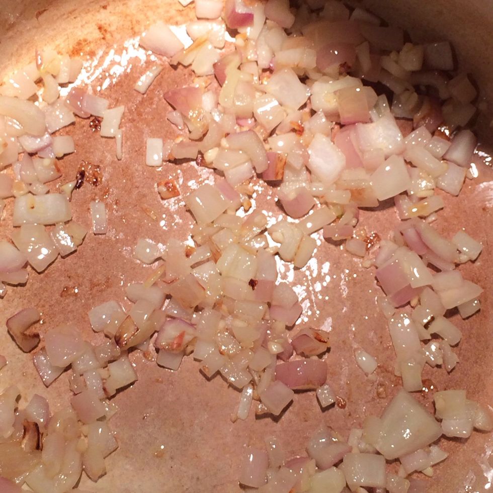Saut\u00e9 the shallots and garlic in olive oil, until the shallots lose their color, this will only take few minutes.