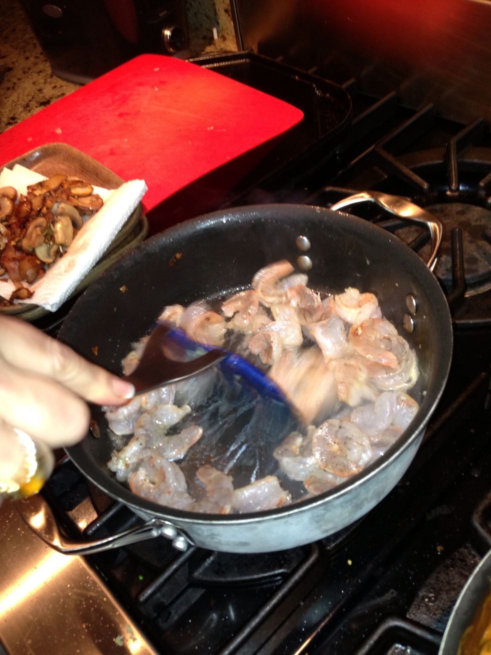Saut\u00e9 the shrimp and remaining garlic until the shrimp is barely turning pink about 2-3 minutes.