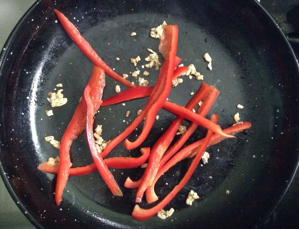 Saute the garlic with olive oil. Them add the red pepper. Leave it for 5 minutes.