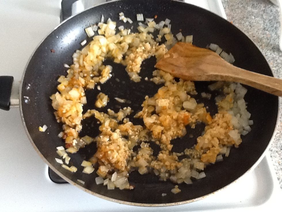 Saute the onion and the garlic in the pan until cooked, but not brown.