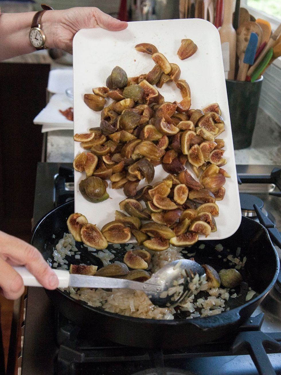 Saute the onions until they turn soft. Now add the quartered figs into the pan.