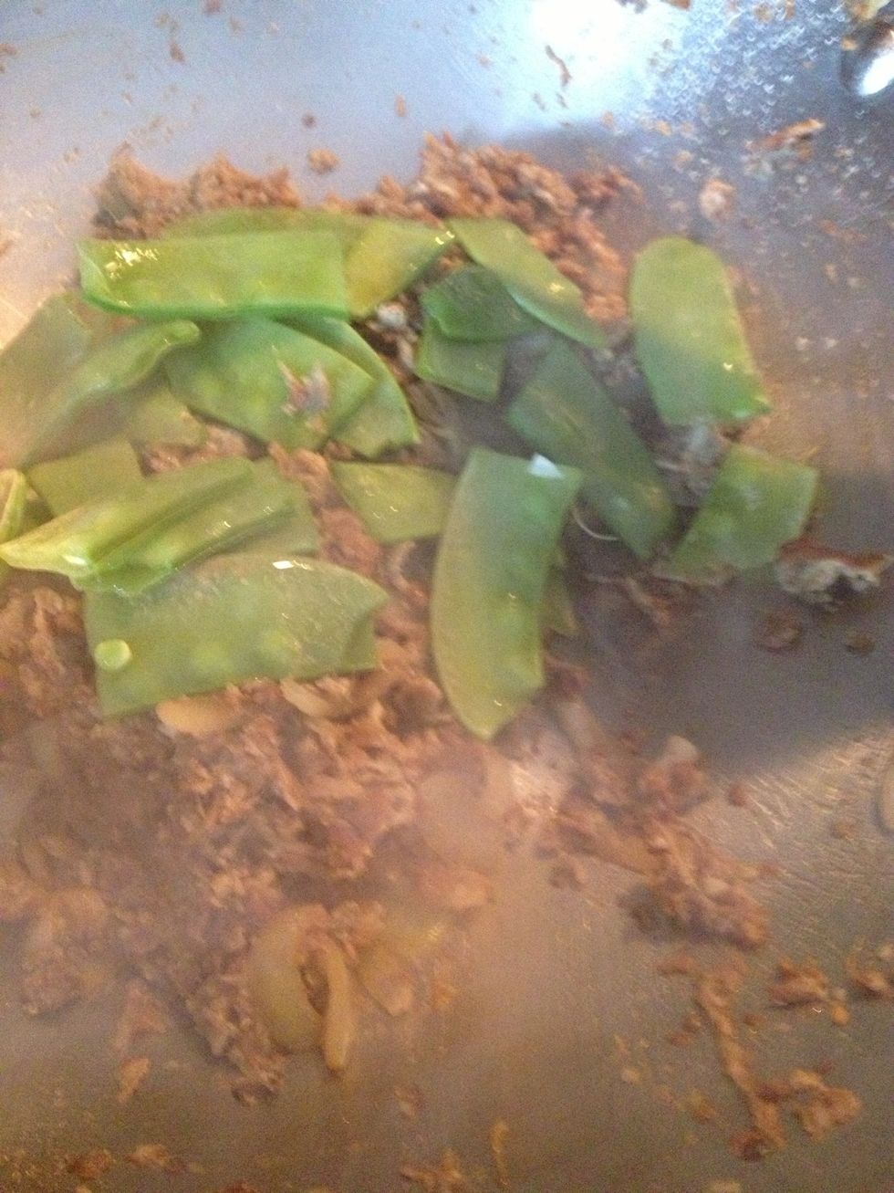 Sautee further. Add the snow peas.