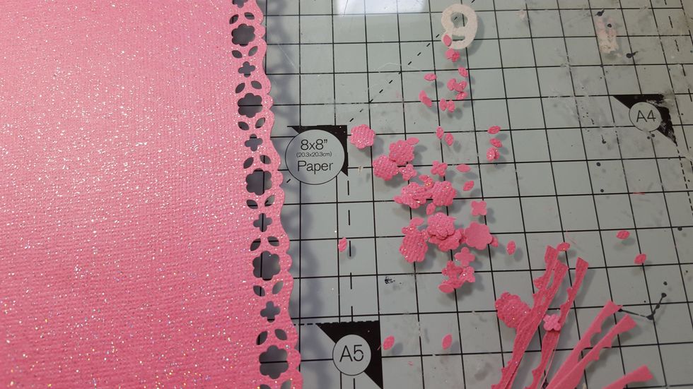Save the small flowers from the pieces that have been punched out of the paper.