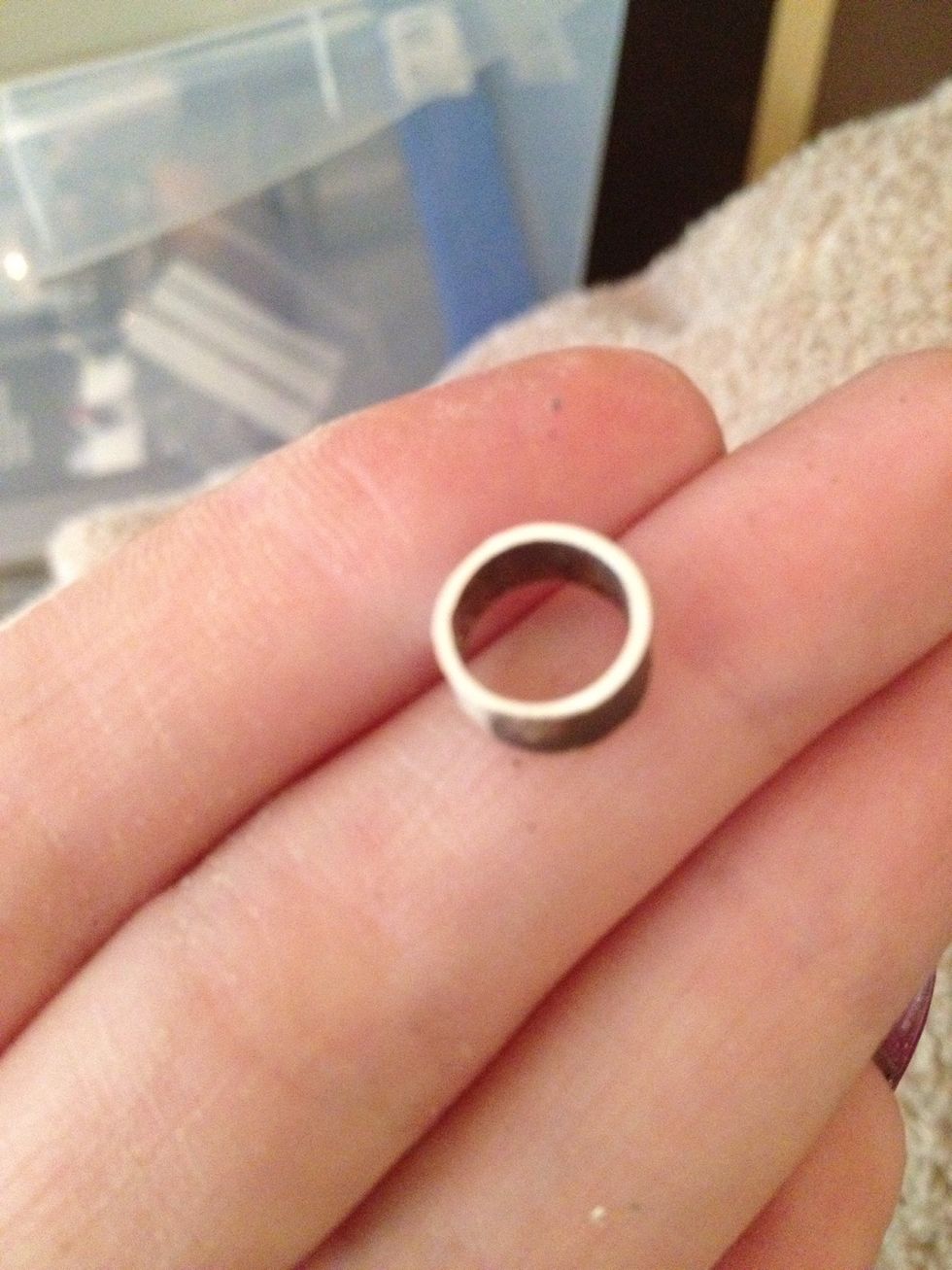 Saw pierce, file and buff, bend into a rough oval shape and solder. You can then on a small mandrel, hammer the bezel into a perfect round shape. Then with parallel pliers, squeeze to the oval shape.