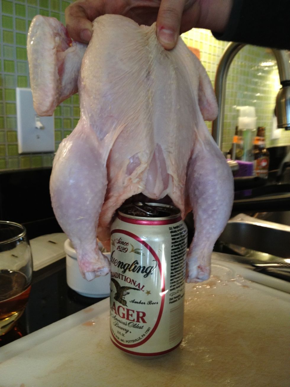 Say you're sorry to the bird and put it down over the beer can with legs on either side.