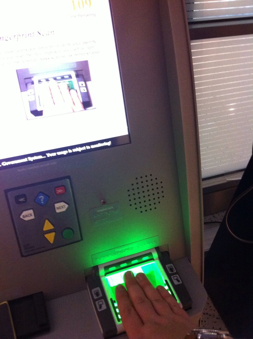 Scan your passport at an open kiosk, then get your mugshot taken and show them your finger prints.