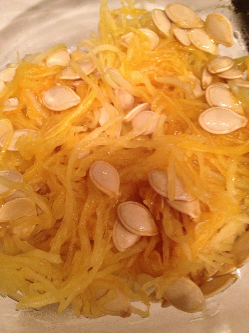 Scape seeds out with a large spoon and place in a bowl to discard.