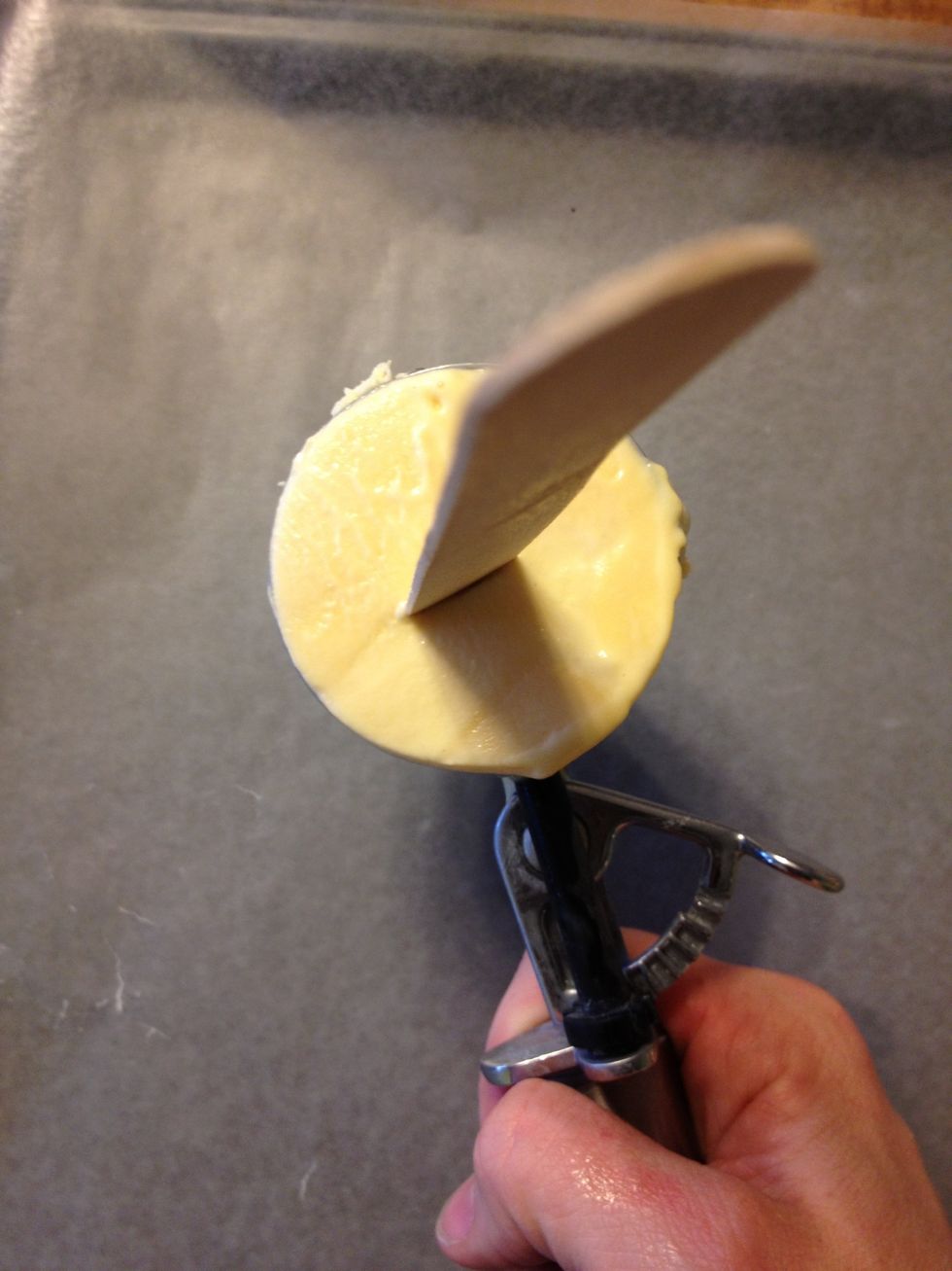 Scoop ice cream & pull off excess against the side of the container so it's flat. Insert stick in middle of scoop.