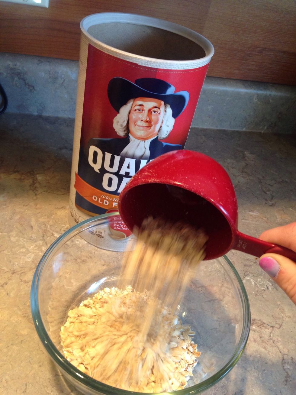Scoop oats and pour into mixing bowl.