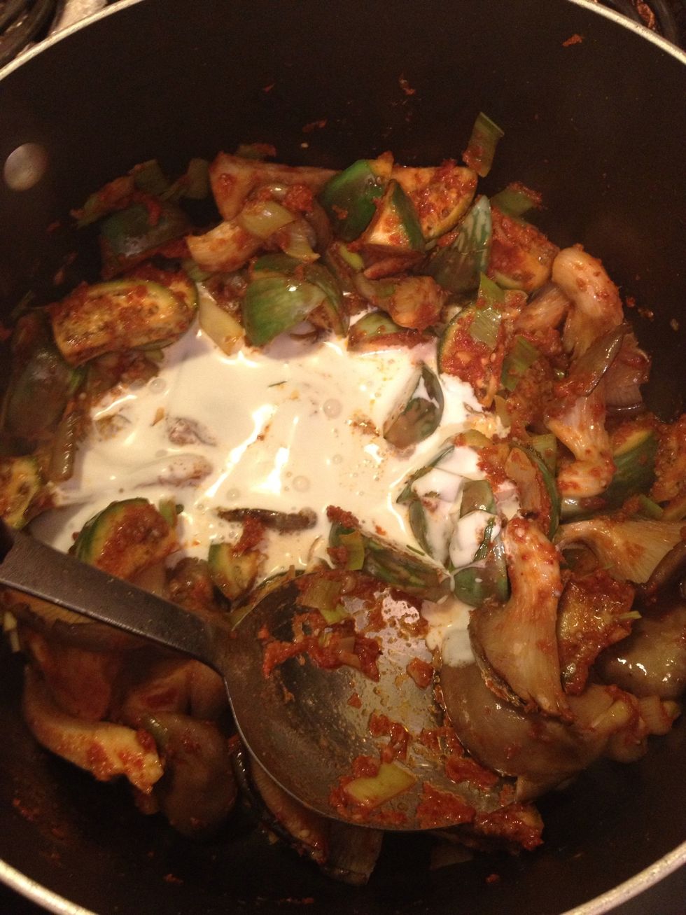 Scoop out the top part of your coconut milk..(the top is where the rich cream floats and has a fattier content.) Add to the stirfry and coated well. Let the coconut milk start to bubble up.