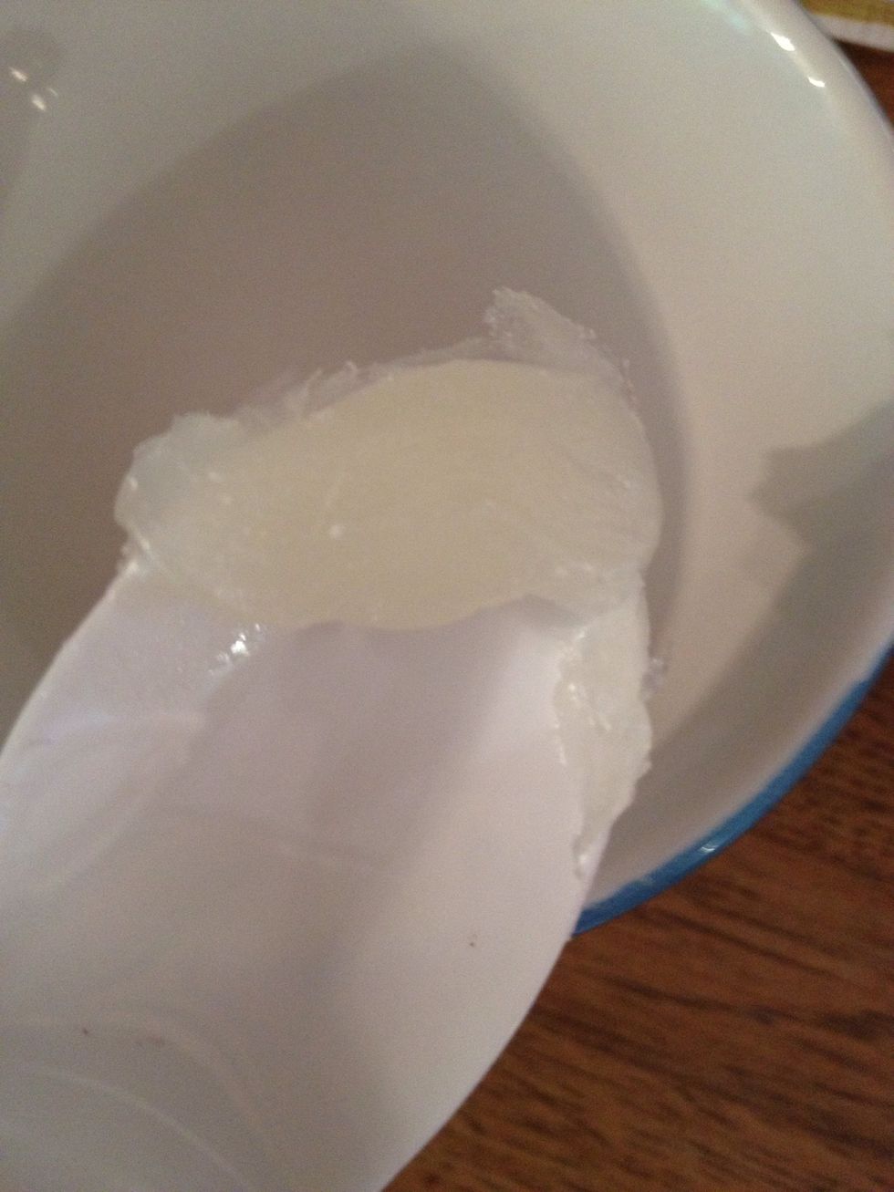 Scoop some petroleum jelly into your container.