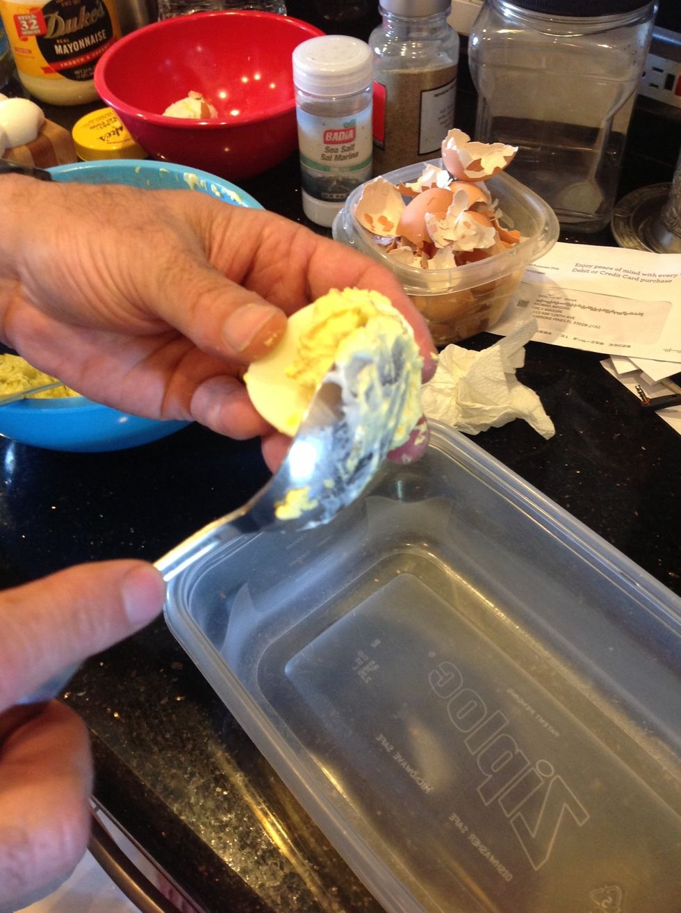 Scoop spoonful into egg half