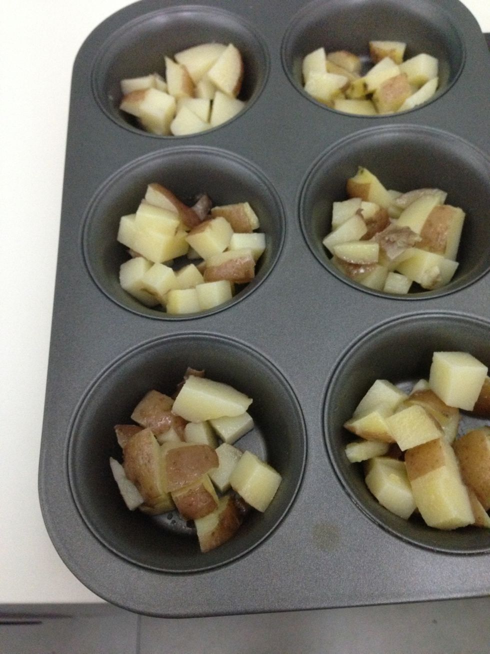 Scoop the cooked potatoes into the muffin tin. Put into the oven at about 200c for about 5-10 mins