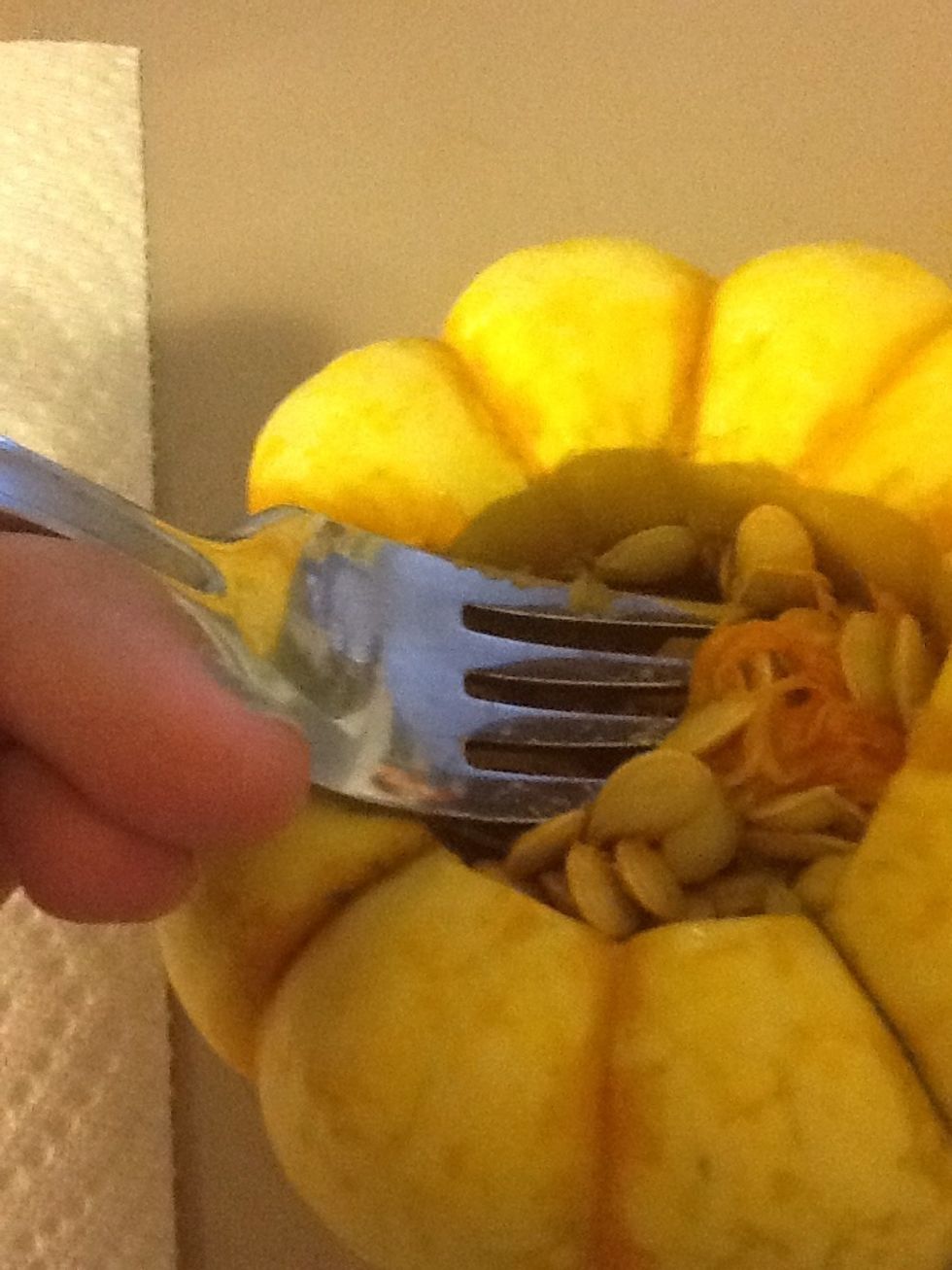 Scoop the seeds and "guts" out of it, like carving a pumpkin.