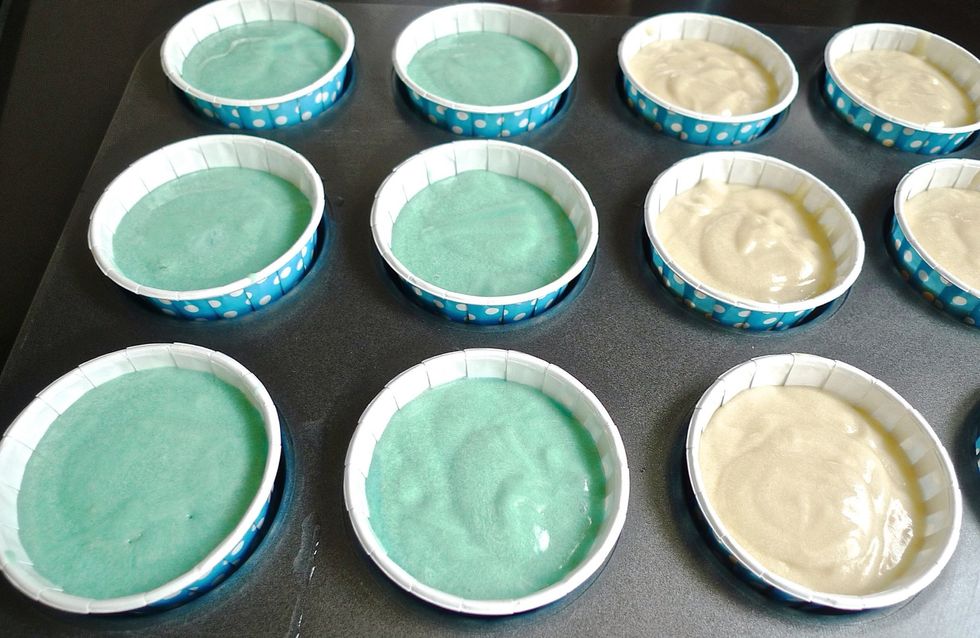 Scoop the vanilla and blue shade batter into the cupcake liners.