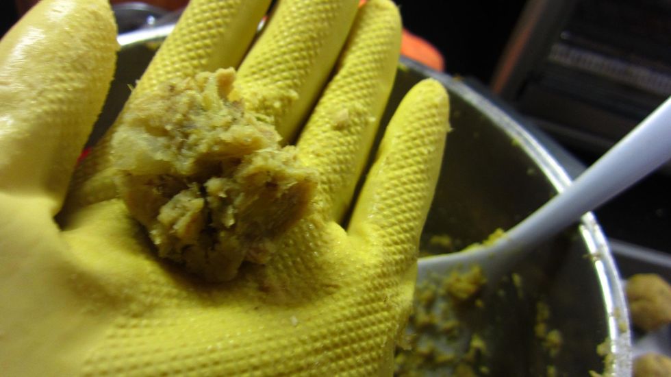 Scoop up a little bit of the fish and potato mixture and using both palms of your hand make it into a ball. Best is to wear gloves since you don't want any food going under your fingernails.