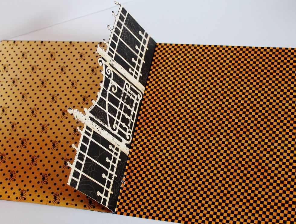 Score 1" from bottom of fence. Adhere to inside of card. Adhere pattern paper to top of scored 1" fence fold of inside of card.