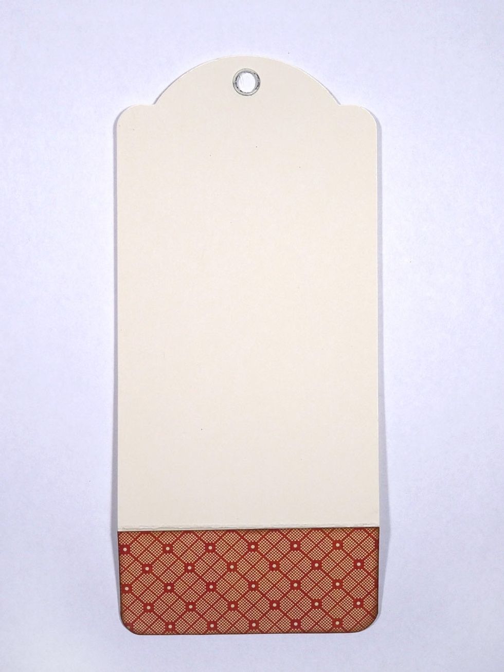 Score a large tag 1 3/4" from the bottom. Fold toward the grommet side of the tag. This will create a pocket later. Cover the pocket with pretty paper.