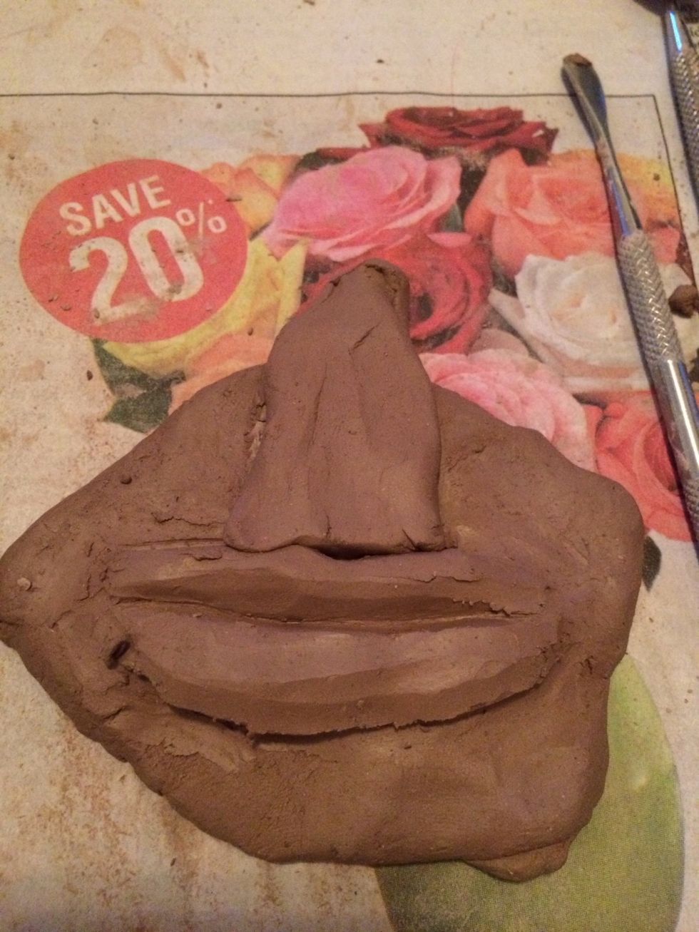 Score and slip to add the triangle above the lips.