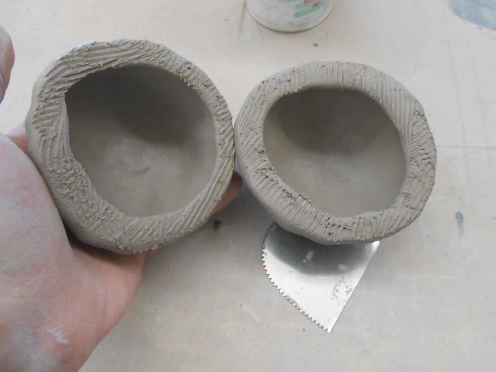 score both rims of the pinch pots