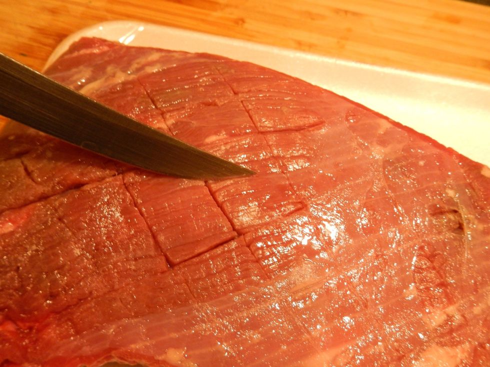 Score the brisket, important to help the marinade soak in and break up the fibrous muscle strands