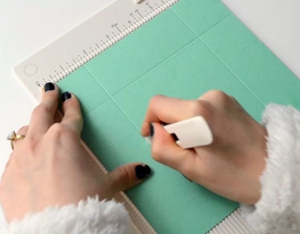 Score the green cardboard .