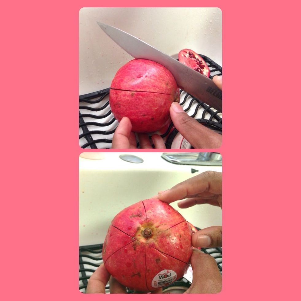 Score the pomegranate all around and cut almost all the way through. I did 6 cuts here.
