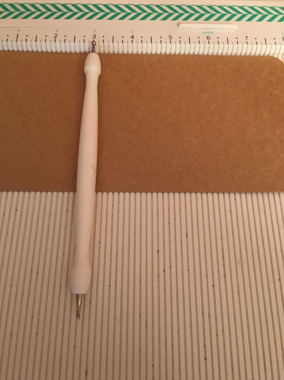 Score the remaining 5 large Kraft tags at the 3 inch mark from the rounded end. This will create pockets.