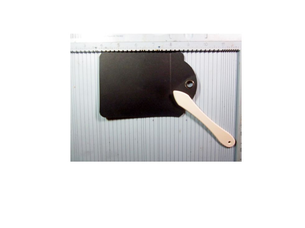 Score the top of a Graphic 45 black tag.
