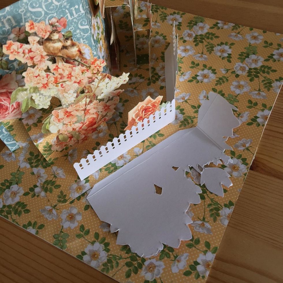 Score to make a tab and glue the piece on the base.