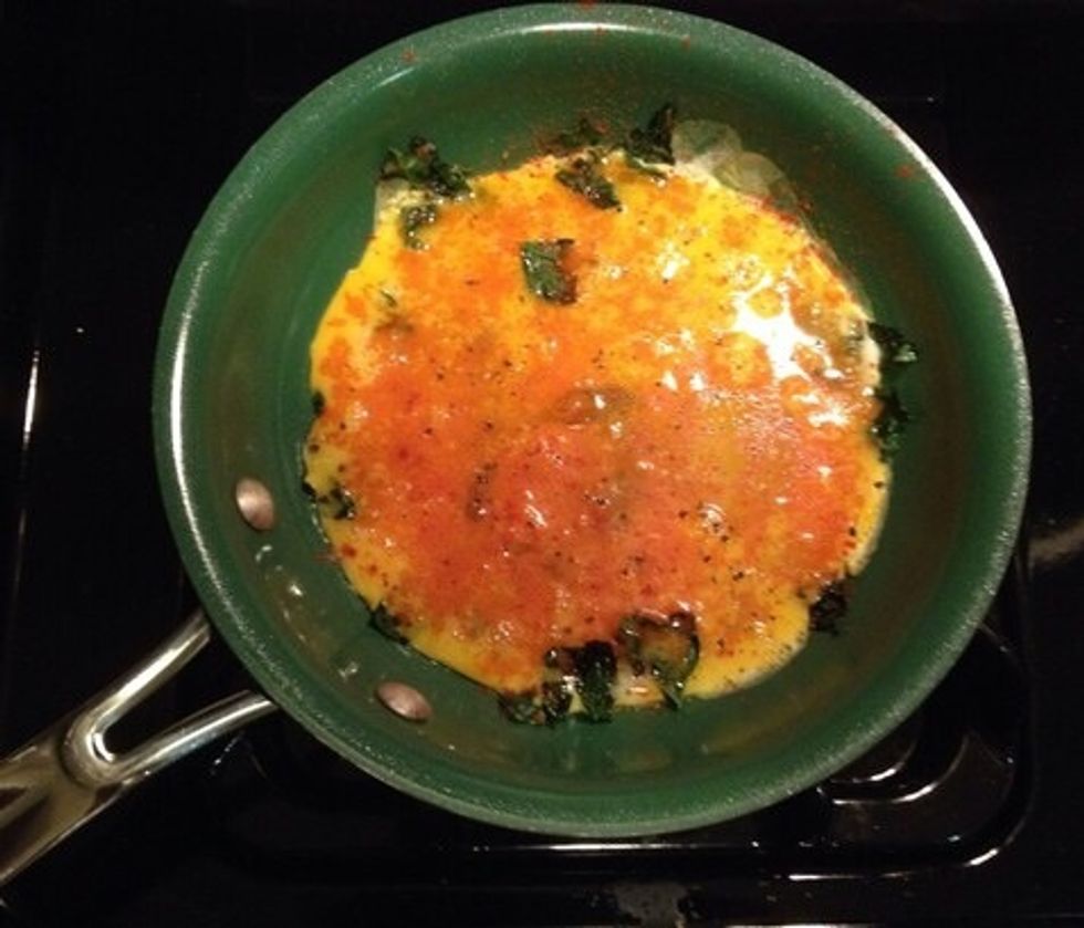 Scramble the eggs and sprinkle on the spices; salt, pepper, garlic powder, paprika.