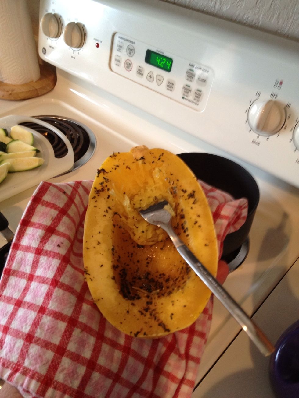 Scrap with a fork to get the meat out. I used a hand towel to hold the squash. Boy these thing hold there heat. Ouch