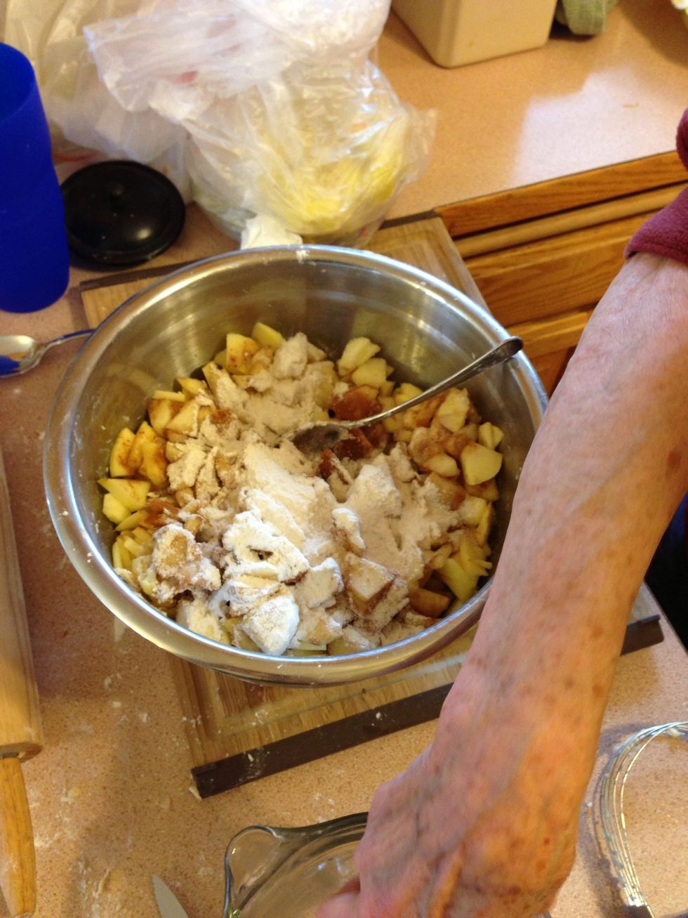 Scrape any excess flour and dough scraps off of the counter around where you rolled the dough and put into the apples.