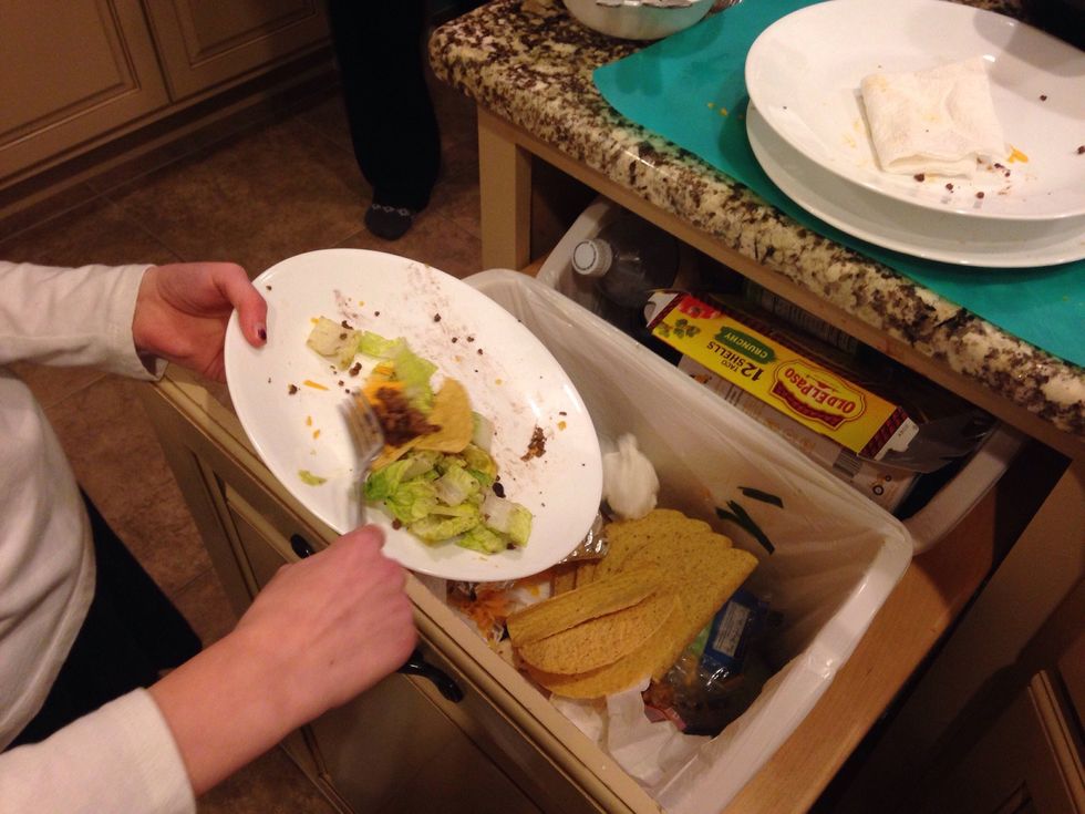 Scrape leftover food into the garbage