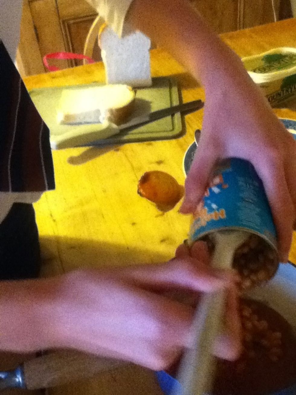 Scrape out the contents in to your pan using your cooking spoon.