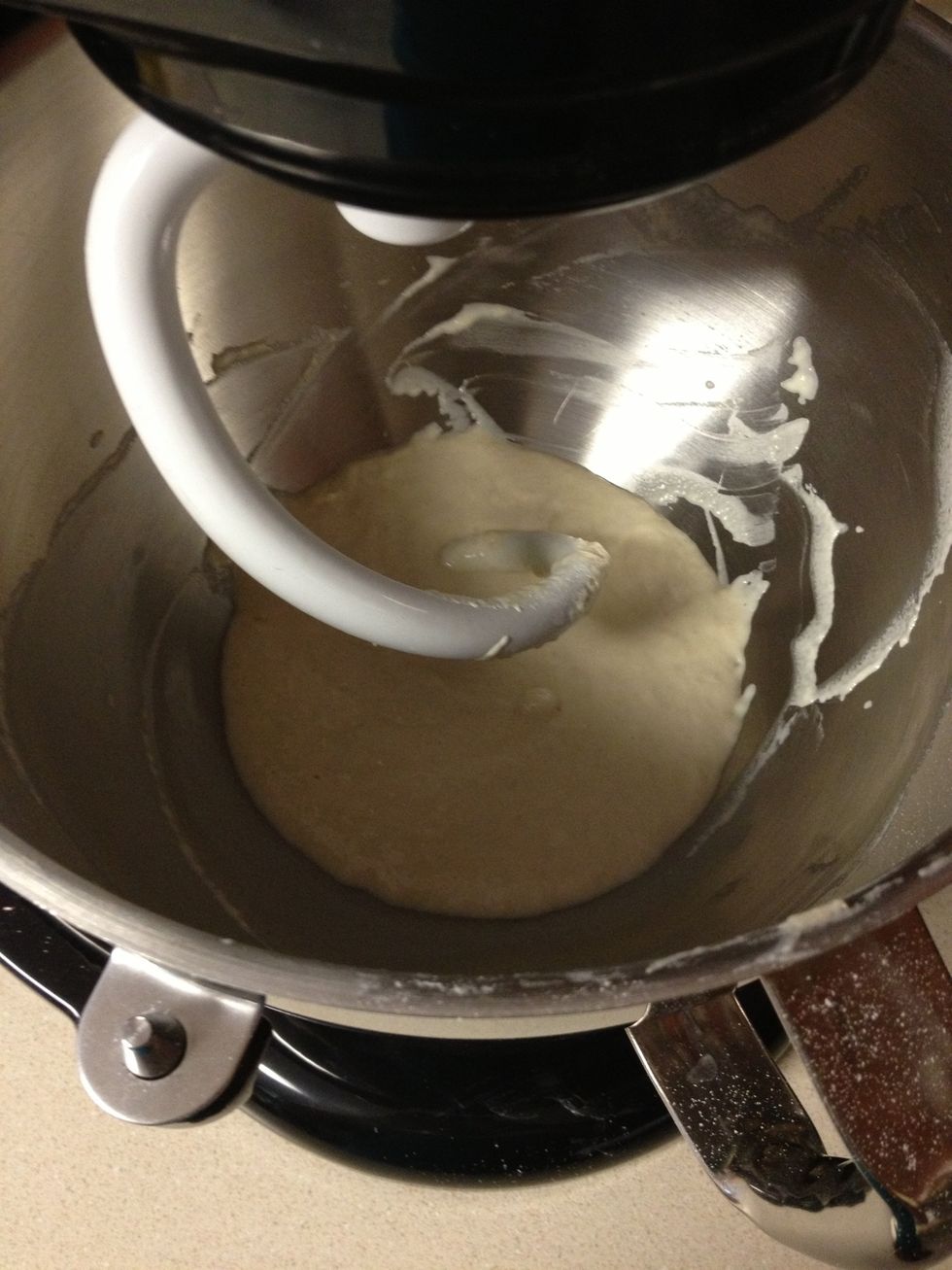 Scrape sides of the bowl to make sure the flour is incorporated, then slowly add more flour until the dough is slightly sticky and is pulling cleanly away from the sides