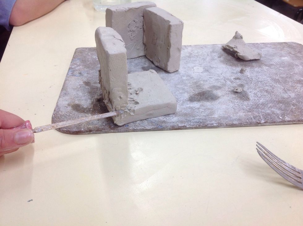 Scrape the clay over the two squares as shown