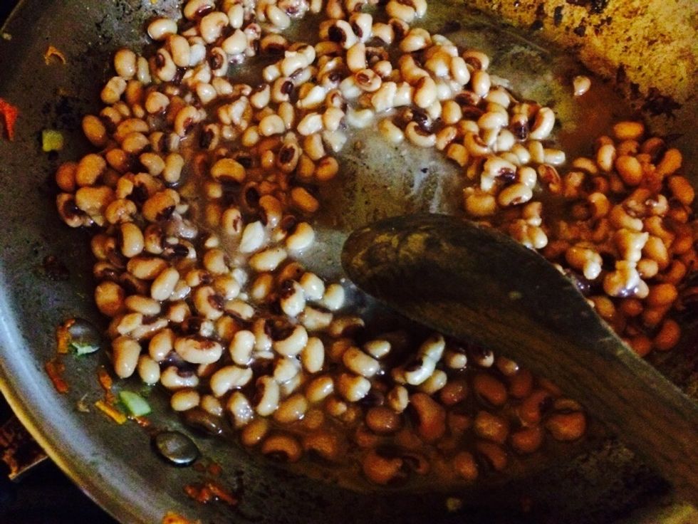 Scrape the pan letting the bean juice grab that flavor. Allow the beans to "cook down" the juice and they will start to pop open. Then they're ready.