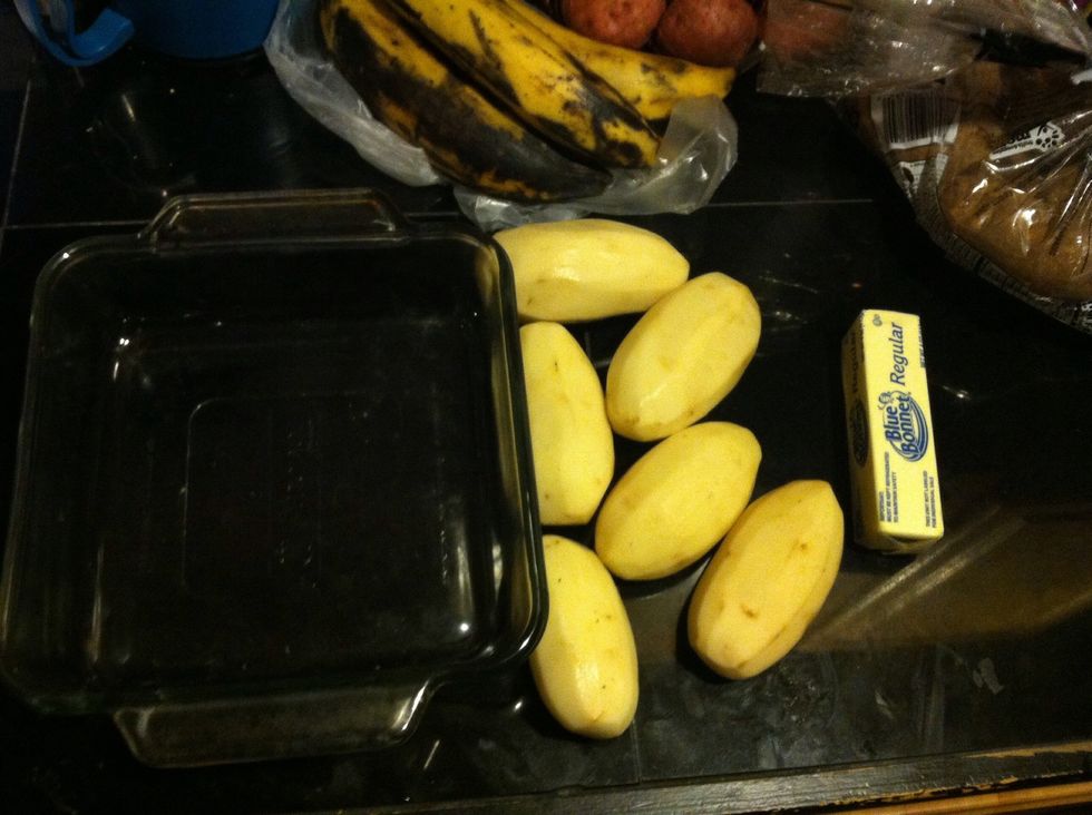 Scrape the skin off your potatoes, butter your pan