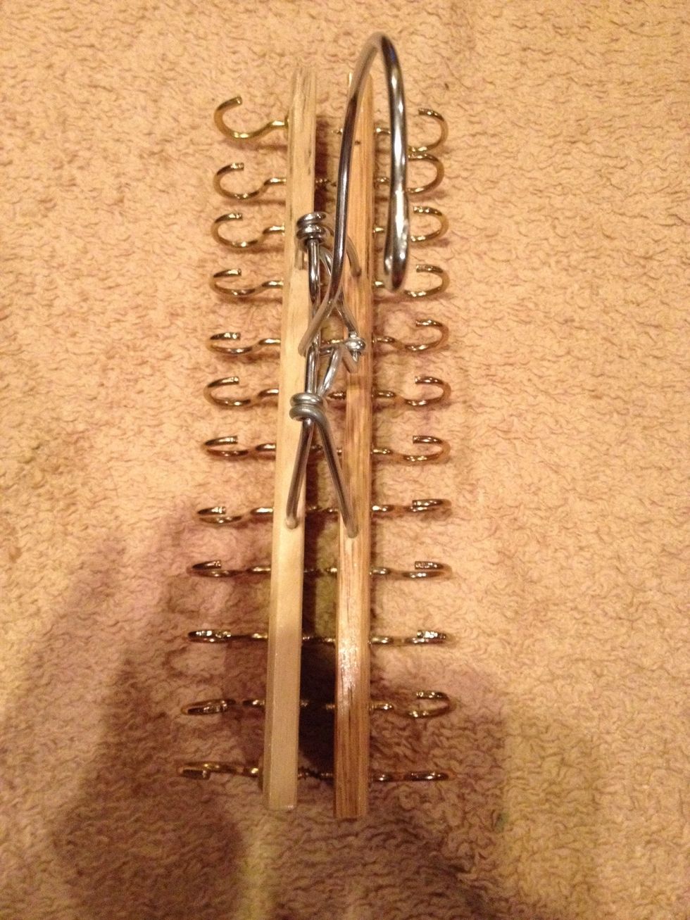 Screw cup hooks in to each hole drilled on both sides. Don't worry about the screw end of the hooks protruding beyond the wood. We'll fix that in a minute.