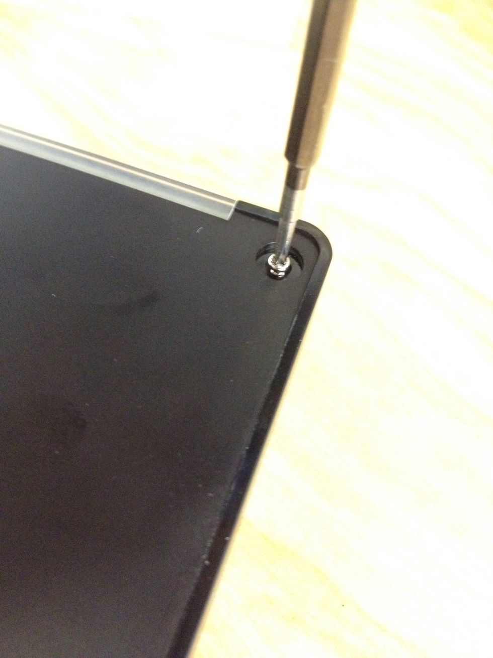 Screw in the 4 long screws to secure the back.