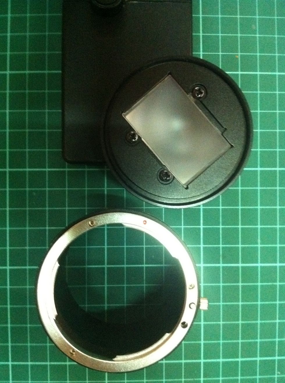 Screw off the long tubular case off the adapter, exposing the gg holder and the focusing screen.