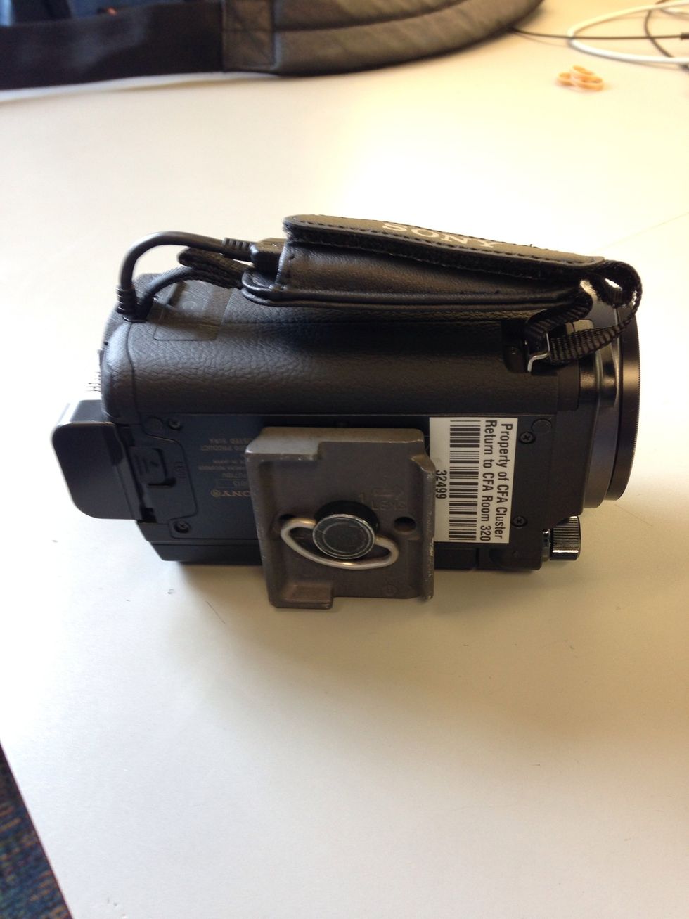 Screw the plate to the bottom of your camera by twisting the silver handle. Make sure the lens is facing the right direction as the mounting plate.