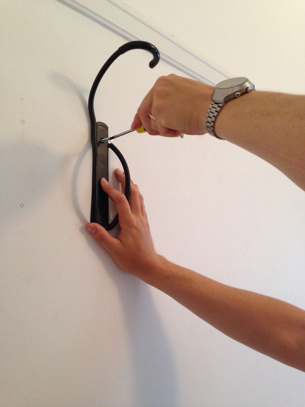 Screw the rack into the wall.