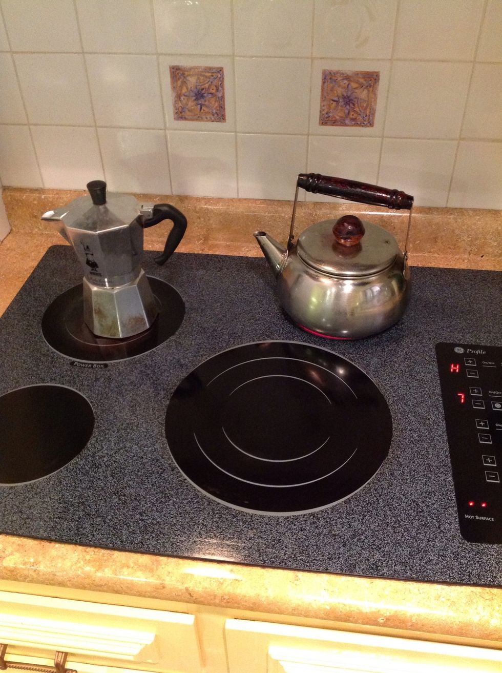 Screw the top on and place it on the stove on medium high heat ( here 7 of 10). Next put water into the kettle and set it on the stove to boil on high heat. They will both finish about the same time.