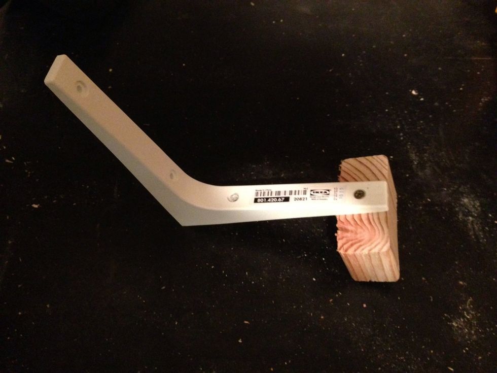 Screw your shelving bracket to your wood, I used the outer screw hole.