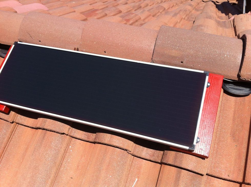 Screwed solar panel to wood mounts on roof using adapters that came with solar panel. Using wire nuts attached wiring to panel. Positive (+) to positive, negative (\u2013) to negative