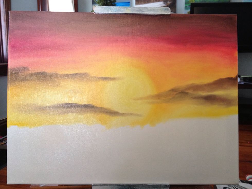 Scrub in your dark drifty clouds. Make it realistic by bringing some across the sun and some off of the canvas.