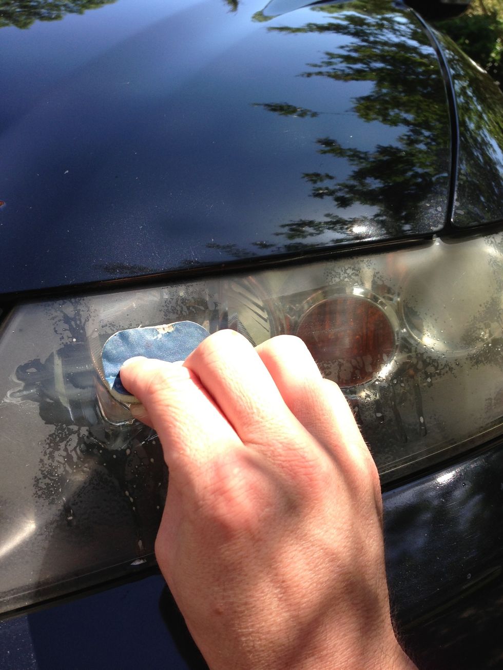 Scrub with a good amount of pressure horizontally and vertically. Make sure to cover entire surface. Be very careful not to touch the painted car surface.